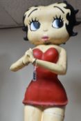 A BETTY BOOP STATUE with hands clasped, in a red dress, a large hand painted and moulded display