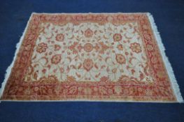 A 20TH CENTURY RECTANGULAR SILK RUG, with beige field, foliate design and multi-strap border,