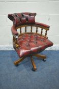 A REPRODUCTION OXBLOOD BUTTONED LEATHER BOW TOP SWIVEL OFFICE CHAIR, width 63cm x depth 62cm x