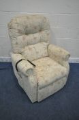 A HSL BEIGE AND FLORAL UPHOLSTERED RISE AND RECLINE ARMCHAIR, width 83cm x depth 86cm x height 110cm