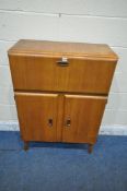 A MID CENTURY OAK COCKTAIL CABINET, the fall front articulated door, opens a hinged lid that's
