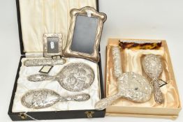 TWO BOXED SILVER VANITY SETS AND TWO SILVER PHOTO FRAMES, the vanity set comprising of a hair brush,