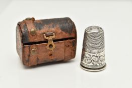 A THIMBLE SCENT BOTTLE AND LEATHER CHEST CASE, the thimble with engraved foliate decoration, the