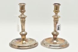 A PAIR OF GEORGE V SILVER CANDLE STICKS, of 18th century style, tapering knopped stems, on a round