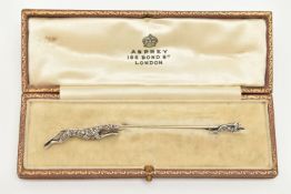 AN EARLY 20TH CENTURY DIAMOND STICK PIN BROOCH, designed as a greyhound chasing a hare, white