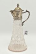 A SILVER MOUNTED GLASS CLARET JUG, cut glass tapering jug with an embossed silver mounted hinged