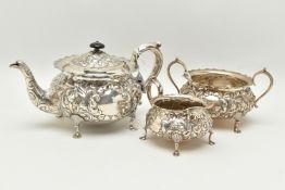 A LATE VICTORIAN SILVER THREE PIECE TEA SET OF CIRCULAR FORM WITH WAVY RIMS, ornately cast with