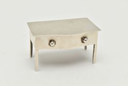 AN EARLY 20TH CENTURY SILVER STAMP HOLDER, in the form of a miniature bow fronted desk, hinged cover