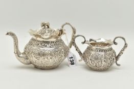 AN INDIAN WHITE METAL TWO PIECE BACHELOR'S TEA SET, comprising teapot and twin handled sugar bowl,
