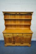 A MODERN PINE DRESSER, the two tier plate rack, atop a base with three drawers, above three cupboard