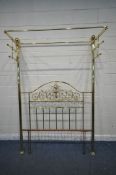 A BRASS 4FT6 HALF TESTER BED, with twin finials, drape holders, scrolled and foliate details (