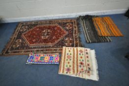 A RECTANGULAR WOOLLEN RUG, with repeating geometric patterns, and a multi-strap border, 194cm x