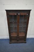 AN OLD CHARM OAK LEAD GLAZED DISPLAY CABINET, the double doors enclosing three glass shelves,