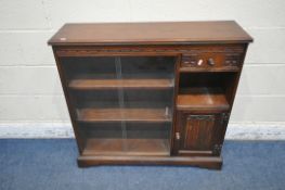 AN OLD CHARM BOOKCASE, the double glass sliding doors enclosing two shelves, the single drawer above