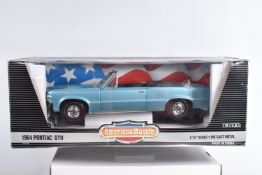 AN ERTL AMERICAN MUSCLE 1:12 SCALE DIECAST MODEL VEHICLE, a 1964 Pontiac GTO Convertible, light