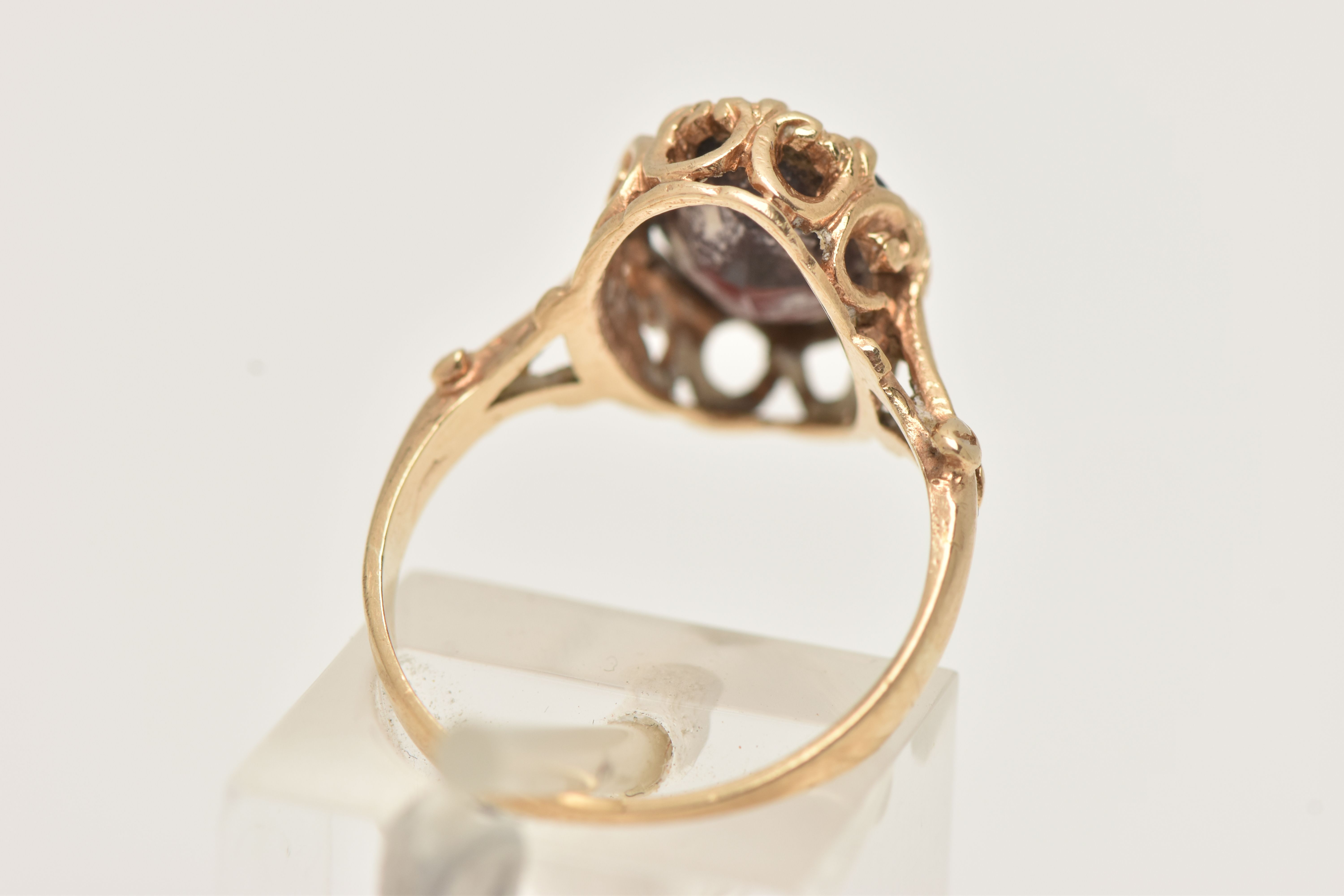 A 9CT GOLD GARNET RING, the oval garnet in an eight claw setting, to the scrolling gallery and - Image 3 of 4
