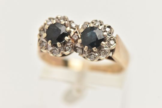 A 9CT GOLD SAPPHIRE AND DIAMOND DOUBLE CLUSTER RING, designed as two round clusters, each set with a - Image 1 of 4