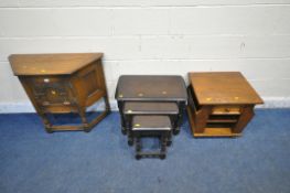 AN OLD CHARM OAK SIDE TABLE, with a single door, raised on turned legs, united by stretchers,