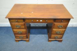 A REPRODUCTION KNEEHOLE DESK, fitted with seven assorted drawers, raised on bracket feet, width