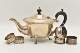 AN EARLY 20TH CENTURY SILVER TEAPOT AND FIVE NAPKIN RINGS, polished teapot with beaded rim, raised