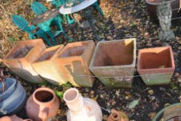 A COLLECTION OF TERRACOTTA COLOURED LARGE PLANT POTS including three square tapering baluster pots