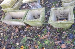THREE WEATHERED COMPOSITE PLANTERS, two are 39cm square the other is 69cm wide and 39cm deep, all