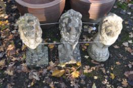 A PAIR OF WEATHERED COMPOSITE GARDEN LION FIGURES, heights 55cm, and a similar lion figure Condition