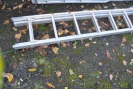 AN ALUMINIUM DOUBLE EXTENSION LADDER, with 13 rungs to each 390cm section and a folding platform