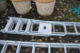 A SHORT ALUMINIUM DOUBLE EXTENSION LADDER with seven rungs to each 200cm section and a step