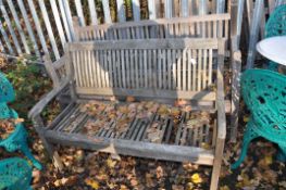 TWO MODERN WEATHERED HARDWOOD GARDEN BENCHES, both with slatted seats and backs, one 120cm wide, the