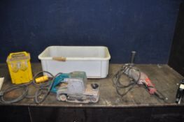 A TRAY CONTAINING A 110V TRANSFORMER, a 4in belt sander (110v possibly an old Makita) and a Sealey