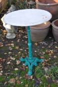 A VICTORIAN STYLE CAST IRON PUB TABLE, with tripod base and white marble top, 59cm in diameter and