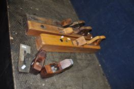 A COLLECTION OF FIVE VINTAGE WOODEN PLANES including a compassing coffin plane, a coffin plane (