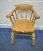 A LATE 20TH CENTURY BEECH BOW TOP SMOKERS CHAIR, the swept armrests with turned supports, raised