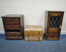 A LATE 20TH CENTURY OAK MEDIA CABINET, with a hinged lid, single lead glazed door, above a linenfold