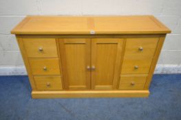 MORRIS FURNITURE COMPANY, A MODERN SOLID OAK SIDEBOARD, fitted with six drawers, flanking double