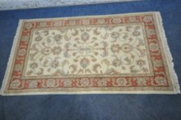 A FRITH RUGS RECTANGULAR INDO KESHAN RUG, with repeating foliate patterns, surrounded by a multi-