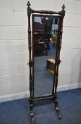 AN EARLY 20TH CENTURY MAHOGANY CHEVAL MIRROR, with twin finials, turned supports, raised on swept