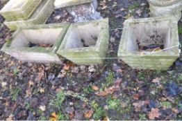 THREE WEATHERED COMPOSITE PLANTERS, two are 39cm square the other is 69cm wide and 39cm deep, all