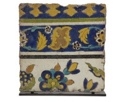 A Safavid cuerda-seca border pottery border tile, Persia, late 17th century, of square form, the ...