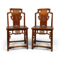 A pair of Chinese hardwood chairs 20th century The scrollwork backs with the centre carved in t...