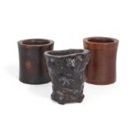 Three Chinese hardwood brush pots Late Qing dynasty Comprising two cylindrical brush pots with ...