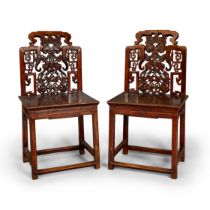 A pair of Chinese hardwood chairs 20th century The fretwork backs with the centre pierced and c...