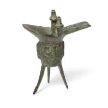 A Chinese bronze archaic ritual wine vessel, jue Shang dynasty Typically standing on tripod bla...
