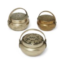 Three Chinese Paktong and copper alloy handwarmers Qing dynasty, 19th century Each with a pierc...
