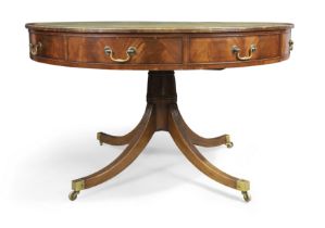 An English mahogany library drum table, of George III style, 20th century, the tooled leather top...