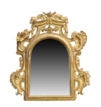 An Italian giltwood wall mirror, 18th century, the arched moulded frame set with later mirror pla...