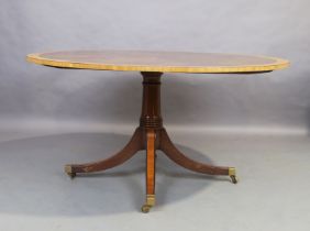 An English mahogany and satinwood crossbanded circular dining table, possibly by William Tillman,...