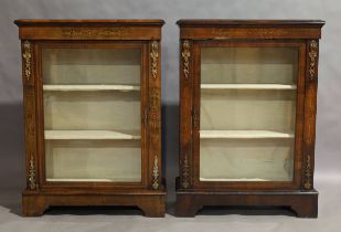 A pair of Victorian walnut pier cabinets, circa 1870, boxwood inlaid, gilt metal mounted, raised ...