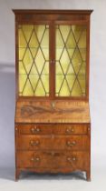 A George III inlaid mahogany bureau bookcase, last quarter 18th century, the stepped cornice abov...